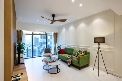 a living room with a green couch and a window at Eaton Residence KLCC by GB in Kuala Lumpur