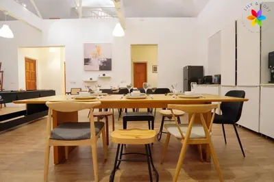 a dining room with a wooden table and chairs at 30P White House Retreat - Pool & Event Hall in Kuala Lumpur