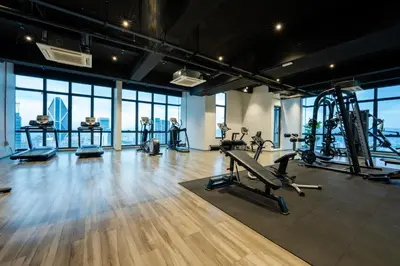 a gym with treadmills and exercise equipment in a building at Moonway Luxury Suites At TM KLCC City Center in Kuala Lumpur