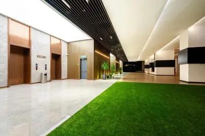 an empty lobby with a green lawn in the middle at Moonway Luxury Suites At TM KLCC City Center in Kuala Lumpur