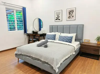 a bedroom with a large bed and a mirror at The Heritage Mid Valley l KL Sentral l 8 Pax in Kuala Lumpur