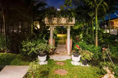 a garden with a gate and potted plants at The Heritage Mid Valley l KL Sentral l 8 Pax in Kuala Lumpur
