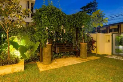 a garden with a bench in the yard at The Heritage Mid Valley l KL Sentral l 8 Pax in Kuala Lumpur