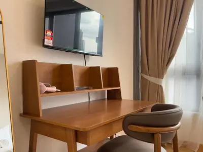 a wooden desk with a chair in a room at Agile Bukit Bintang FaceHome, TRX, Pavilion, KL in Kuala Lumpur
