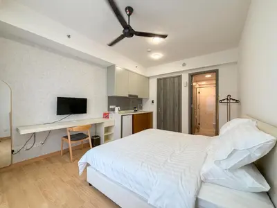 a bedroom with a bed and a desk with a computer at Agile Bukit Bintang FaceHome, TRX, Pavilion, KL in Kuala Lumpur