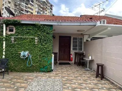 a house with a green wall next to a house at Miharja Studio Private room with Auto gate Parking in Kuala Lumpur