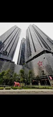 two tall skyscrapers with rain on them at Star Residences One in Kuala Lumpur