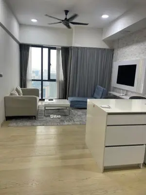 a living room with a couch and a ceiling fan at Star Residences One in Kuala Lumpur
