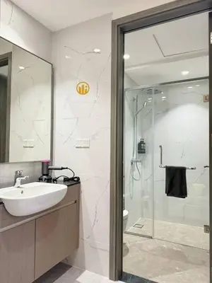 a bathroom with a sink and a glass shower at Agile Residence Bukit Bintang By Heystay Management in Kuala Lumpur