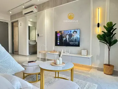 a living room with a tv on a wall at Agile Residence Bukit Bintang By Heystay Management in Kuala Lumpur