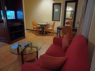 a living room with a red couch and a table at Kuala Lumpur Grand service suite at Times Square in Kuala Lumpur