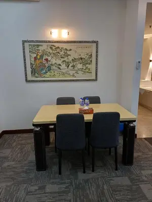 a meeting room with two tables and chairs at Kuala Lumpur Grand service suite at Times Square in Kuala Lumpur