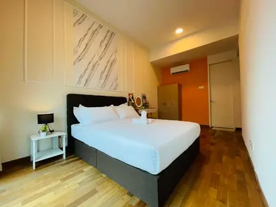 a bedroom with a large white bed and a wooden floor at Reizz Residence Ampang by DeUrban in Kuala Lumpur