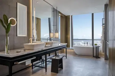 a bathroom with two sinks and a tub and a large window at Park Hyatt Kuala Lumpur in Kuala Lumpur