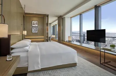 a bedroom with a large bed and a flat screen tv at Park Hyatt Kuala Lumpur in Kuala Lumpur