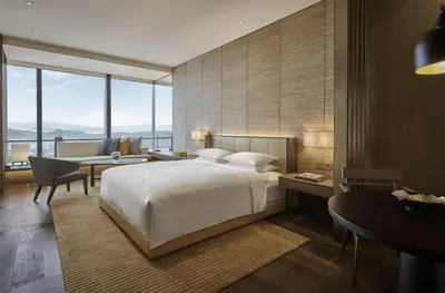 a bedroom with a bed and a desk and a couch at Park Hyatt Kuala Lumpur in Kuala Lumpur