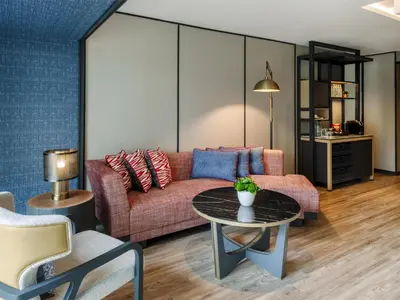 a living room with a couch and a table at Hyatt Centric City Centre Kuala Lumpur in Kuala Lumpur