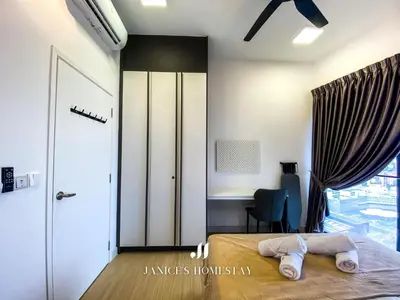 a bedroom with a bed and a desk and a window at Continew Residence by Janice's Homestay in Kuala Lumpur