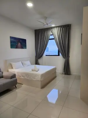 a bedroom with a bed and a couch and a window at Chambers Residence Suites Couple Studio in Kuala Lumpur