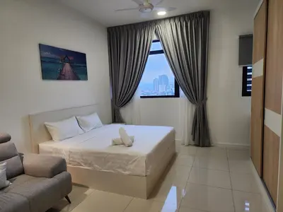 a bedroom with a bed and a chair and a window at Chambers Residence Suites Couple Studio in Kuala Lumpur