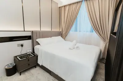 a hotel room with two beds and a window at Brilliant Hotel Dan Spa in Kuala Lumpur