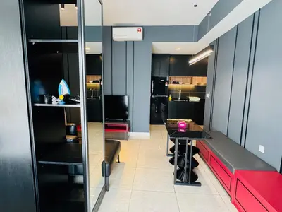 a room with a red bench and a table at AXON Residences Kuala Lumpur in Kuala Lumpur