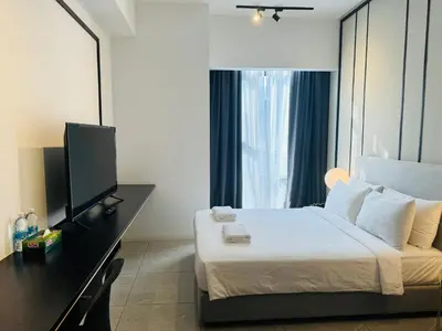 a hotel room with a bed and a flat screen tv at AXON Residences Kuala Lumpur in Kuala Lumpur