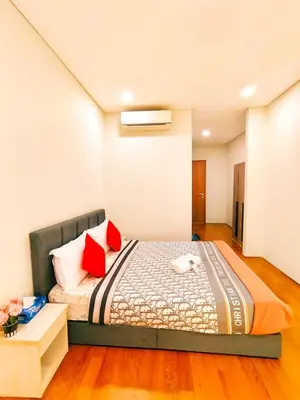 a bedroom with a bed with red pillows at Sky Suites KLCC by KD Luxury Suites in Kuala Lumpur