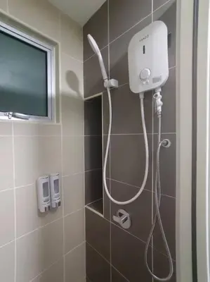 a shower in a bathroom with a television on the wall at KLCC View 3BR 3Bath at RC Residence by Rosaz in Kuala Lumpur
