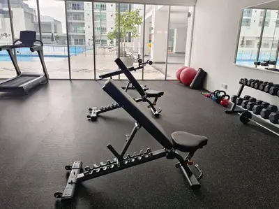a gym with tread machines and a swimming pool at KLCC View 3BR 3Bath at RC Residence by Rosaz in Kuala Lumpur
