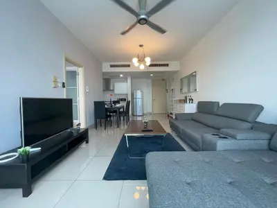 a living room with a couch and a flat screen tv at Solaris Dutamas by Manhattan Group in Kuala Lumpur