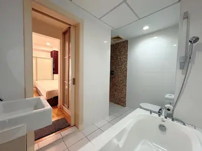 a white bathroom with a tub and a sink at Solaris Dutamas by Manhattan Group in Kuala Lumpur