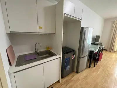a small kitchen with a sink and a refrigerator at Solaris Dutamas by Manhattan Group in Kuala Lumpur