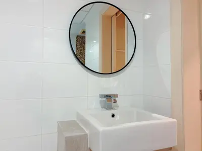 a bathroom with a white sink and a mirror at Solaris Dutamas by Manhattan Group in Kuala Lumpur