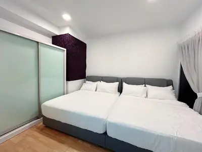 a bedroom with two beds with white sheets at Solaris Dutamas by Manhattan Group in Kuala Lumpur