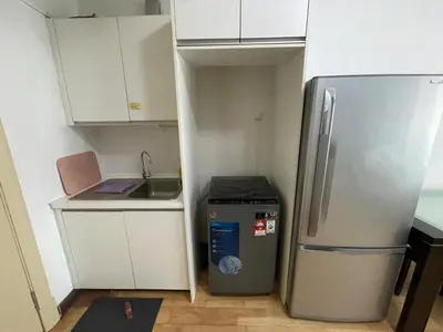 a small kitchen with a refrigerator and a sink at Solaris Dutamas by Manhattan Group in Kuala Lumpur