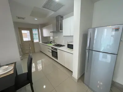 a kitchen with a stainless steel refrigerator and white cabinets at Solaris Dutamas by Manhattan Group in Kuala Lumpur