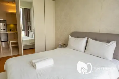 a white bed with white pillows in a room at The Signature Serviced Apartment at Sri Hartamas in Kuala Lumpur