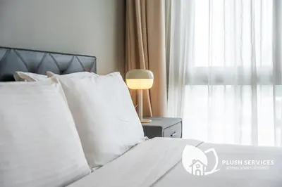 a bedroom with a bed with white pillows and a window at The Signature Serviced Apartment at Sri Hartamas in Kuala Lumpur