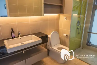 a bathroom with a toilet and a sink and a shower at The Signature Serviced Apartment at Sri Hartamas in Kuala Lumpur