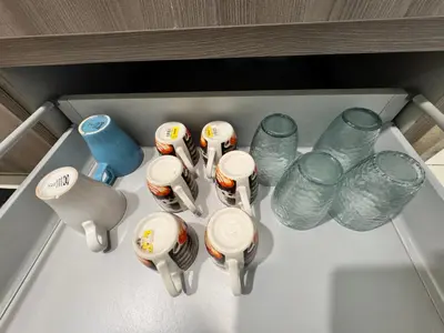 a drawer with cups and glasses in a refrigerator at Velocity KL by Homestay in Kuala Lumpur