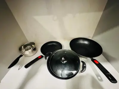 two pans and utensils sitting on top of a counter at Velocity KL by Homestay in Kuala Lumpur