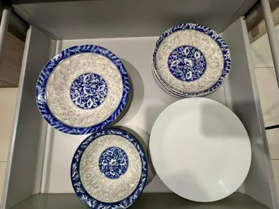 four blue and white plates on a shelf at Velocity KL by Homestay in Kuala Lumpur