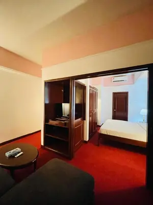 a hotel room with a bed and a desk at Royal empire suite At Times square kl in Kuala Lumpur