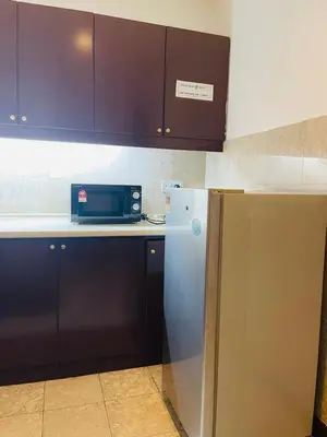 a kitchen with a microwave and a refrigerator at Royal empire suite At Times square kl in Kuala Lumpur
