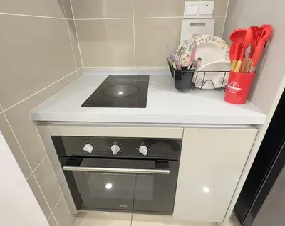 a kitchen with a stove and a counter top at KLCC View 1BR cozy suite with Balcony Trion B5310 KL in Kuala Lumpur