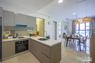 a kitchen with white cabinets and a dining room at Suitable for Long Stay For 2-4 Trion Bukit Bintang Near KL KLCC in Kuala Lumpur
