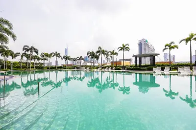 a large pool of water with palm trees and buildings at Suitable for Long Stay For 2-4 Trion Bukit Bintang Near KL KLCC in Kuala Lumpur