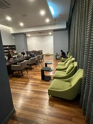 a waiting room with a row of chairs and tables at Regalia Infinity Skypool in Kuala Lumpur