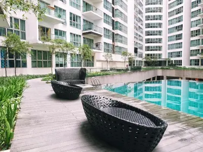 a patio with chairs and a pool in a building at Regalia Infinity Skypool in Kuala Lumpur